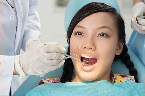 Dentist showing proper brushing technique